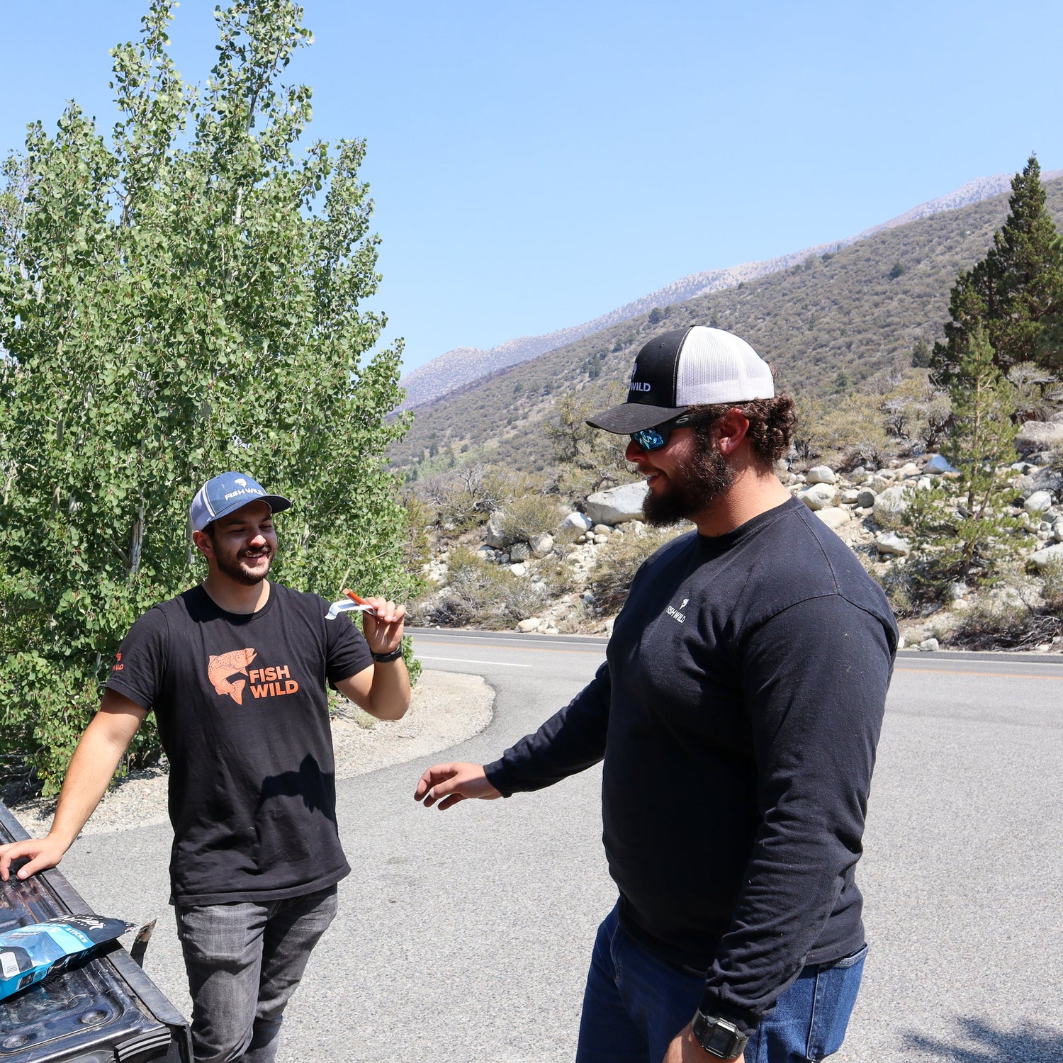 Man Outdoors Wearing Fly Fishing T-Shirt by Fish Wild USA