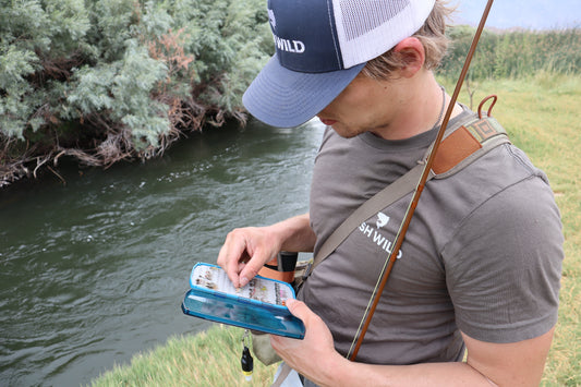 Fly Angler picking out a fly he tied
